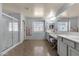 Expansive main bathroom with double sinks, a shower, a window, and a vanity area with bench at 3863 S Posse Trl, Gilbert, AZ 85297