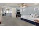 Comfortable main bedroom with a TV, fan, and a walk through to an area for the Primary closet and bathroom at 3863 S Posse Trl, Gilbert, AZ 85297