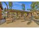 Pergola with tables and seating, barbeque and trash receptacle, offering a space to enjoy community at 3863 S Posse Trl, Gilbert, AZ 85297