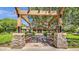 Pergola covered walkway and bench seating leading to Power Ranch clubhouse on a sunny day at 3863 S Posse Trl, Gilbert, AZ 85297