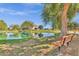 Scenic pond with seating and barn, perfect for relaxation in this inviting community at 3863 S Posse Trl, Gilbert, AZ 85297