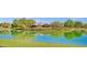 Scenic pond with the reflection of a community clubhouse, offering a tranquil setting at 3863 S Posse Trl, Gilbert, AZ 85297