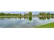 Picturesque pond bordered by lush greenery and a stone bridge, creating a serene community view at 3863 S Posse Trl, Gilbert, AZ 85297