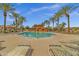 Community pool with lounge seating and a pool house, surrounded by palm trees at 3863 S Posse Trl, Gilbert, AZ 85297