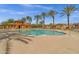 Large community pool with views of palm trees, pool house and community buildings at 3863 S Posse Trl, Gilbert, AZ 85297