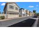 Street view of townhomes with two car garages in a suburban neighborhood on a sunny day in Arizona at 3863 S Posse Trl, Gilbert, AZ 85297
