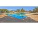 Sparkling community swimming pool with lap lanes and abundant seating areas for residents to enjoy at 3863 S Posse Trl, Gilbert, AZ 85297