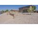 Backyard featuring desert landscaping, water views, a sparkling pool, and outdoor patio space at 40759 W Bravo Dr, Maricopa, AZ 85138