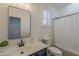 Well-lit bathroom featuring a single sink, black fixtures, and window with modern shutters at 40759 W Bravo Dr, Maricopa, AZ 85138