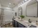 This is a bathroom featuring dual sinks, modern fixtures, and a shower-tub combo at 40759 W Bravo Dr, Maricopa, AZ 85138