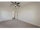 Neutral bedroom with carpet flooring, ceiling fan, and large closet at 40759 W Bravo Dr, Maricopa, AZ 85138