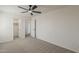 This bedroom includes carpeted floors, a ceiling fan, and white-painted walls at 40759 W Bravo Dr, Maricopa, AZ 85138
