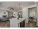Bright kitchen featuring an island with pendant lighting and views of the living room at 40759 W Bravo Dr, Maricopa, AZ 85138