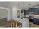 Well-lit kitchen with a central island, stylish seating, and modern appliances at 40759 W Bravo Dr, Maricopa, AZ 85138