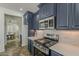 Modern kitchen with stainless appliances, ample counter space, and eat in kitchen table at 40759 W Bravo Dr, Maricopa, AZ 85138