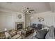 Beautiful living room featuring a fireplace, comfortable seating, and a coffee table centerpiece at 40759 W Bravo Dr, Maricopa, AZ 85138
