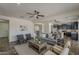 Inviting living space with kitchen access and a comfortable grey sofa with decorative pillows at 40759 W Bravo Dr, Maricopa, AZ 85138