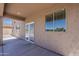 Covered patio featuring tile flooring, windows, and sliding glass doors to the home's interior at 40759 W Bravo Dr, Maricopa, AZ 85138