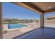 Inviting backyard pool overlooking the water with decorative rocks and nice landscaping at 40759 W Bravo Dr, Maricopa, AZ 85138