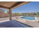 Inviting backyard pool overlooking the water, with decorative rocks and nice landscaping at 40759 W Bravo Dr, Maricopa, AZ 85138