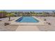 This outdoor swimming pool is surrounded by desert landscaping at 40759 W Bravo Dr, Maricopa, AZ 85138