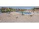 View of pool with patio, waterfront views, desert landscaping, and tropical palm trees at 40759 W Bravo Dr, Maricopa, AZ 85138