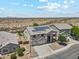 Stunning aerial view of a two-story home with solar panels and a desert landscape backdrop at 4118 N 304Th Ln, Buckeye, AZ 85396