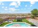 Lush backyard with a sparkling pool, outdoor seating, and beautiful desert views at 4118 N 304Th Ln, Buckeye, AZ 85396