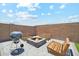 Enclosed backyard featuring a fire pit with grill and wooden benches perfect for outdoor entertaining at 4118 N 304Th Ln, Buckeye, AZ 85396