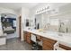 Large bathroom featuring dual sinks, vanity seating, and a glass-enclosed shower at 4118 N 304Th Ln, Buckeye, AZ 85396