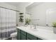 Bathroom with sink, toilet and shower with striped curtain at 4118 N 304Th Ln, Buckeye, AZ 85396