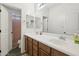 Well-lit bathroom with double sinks, warm wood cabinets, and neutral-toned floors at 4118 N 304Th Ln, Buckeye, AZ 85396