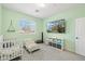 Spacious bedroom with twin beds, a TV, and a bright green wall at 4118 N 304Th Ln, Buckeye, AZ 85396