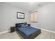 Modern bedroom features a full-sized bed and wood-look floors at 4118 N 304Th Ln, Buckeye, AZ 85396