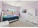 Bright bedroom with lavender walls, white furnishings, and a large window at 4118 N 304Th Ln, Buckeye, AZ 85396