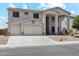 Charming two-story home featuring a two-car garage and welcoming front porch with decorative columns at 4118 N 304Th Ln, Buckeye, AZ 85396