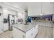 Kitchen island features gray countertop and white cabinets with stainless steel handles at 4118 N 304Th Ln, Buckeye, AZ 85396