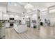 Bright, open kitchen features white cabinetry, stainless steel appliances and a large island at 4118 N 304Th Ln, Buckeye, AZ 85396
