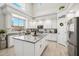 Bright kitchen with white cabinets, a large center island, and ample counter space at 4118 N 304Th Ln, Buckeye, AZ 85396