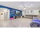 Open-concept living area with a blue accent wall, contemporary furniture, and seamless flow at 4118 N 304Th Ln, Buckeye, AZ 85396