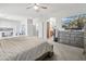 Spacious bedroom boasts soft carpet, ceiling fan, and a large TV at 4118 N 304Th Ln, Buckeye, AZ 85396