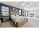 Spacious main bedroom features a large bed, ensuite bathroom and an office space at 4118 N 304Th Ln, Buckeye, AZ 85396