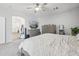 Bright bedroom features soft carpet, ceiling fan and a large TV at 4118 N 304Th Ln, Buckeye, AZ 85396