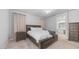 Cozy bedroom featuring neutral tones, large bed with storage and a view of the bathroom at 4341 W Pelotazo Way, San Tan Valley, AZ 85144