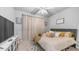 This bright bedroom features neutral colors, a ceiling fan, and a large window for ample natural light at 4341 W Pelotazo Way, San Tan Valley, AZ 85144