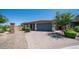 A well-manicured home featuring desert landscaping and a paved driveway at 4341 W Pelotazo Way, San Tan Valley, AZ 85144
