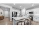 Open-concept kitchen featuring white cabinets, a large island, and stainless steel appliances at 4341 W Pelotazo Way, San Tan Valley, AZ 85144