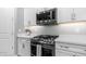 A stainless steel range and microwave installed above the range with white shaker cabinets at 4341 W Pelotazo Way, San Tan Valley, AZ 85144