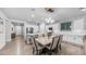 Bright kitchen area featuring white cabinets, light countertops, and a cozy dining space at 4341 W Pelotazo Way, San Tan Valley, AZ 85144
