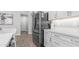 A kitchen featuring a stainless steel LG refrigerator, and white cabinetry with countertops at 4341 W Pelotazo Way, San Tan Valley, AZ 85144